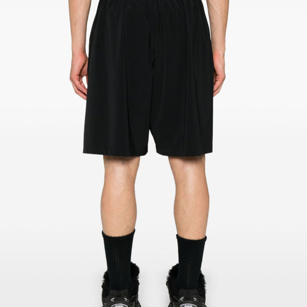 Close-up of Balenciaga pants hardware and fine stitching