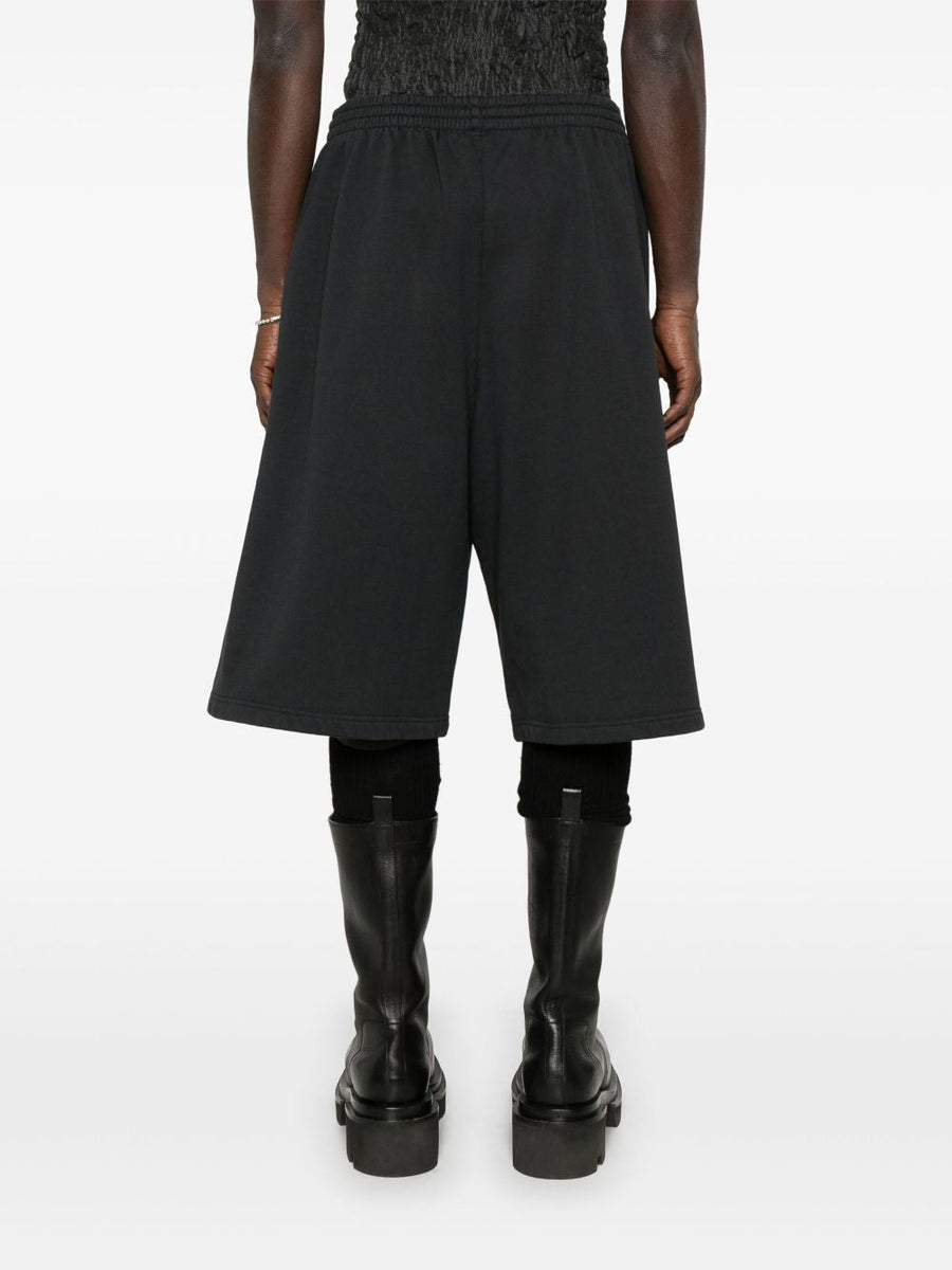 Close-up of Balenciaga pants hardware and fine stitching