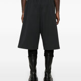 Close-up of Balenciaga pants hardware and fine stitching