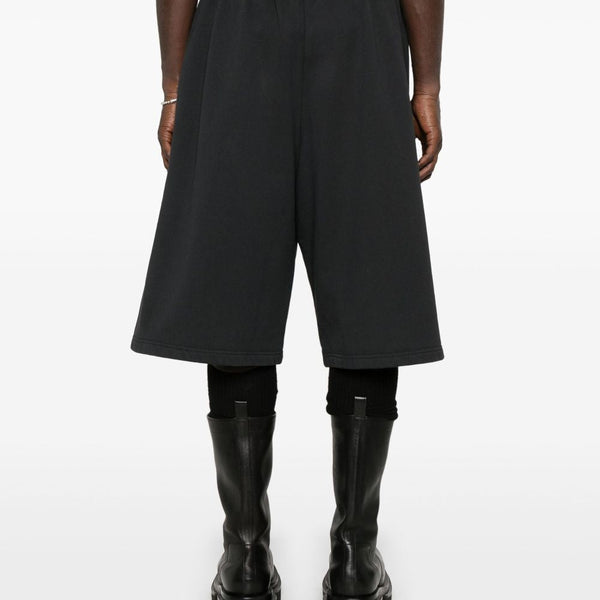 Close-up of Balenciaga pants hardware and fine stitching