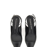 Close-up of Alexander McQueen sandals hardware and fine stitching