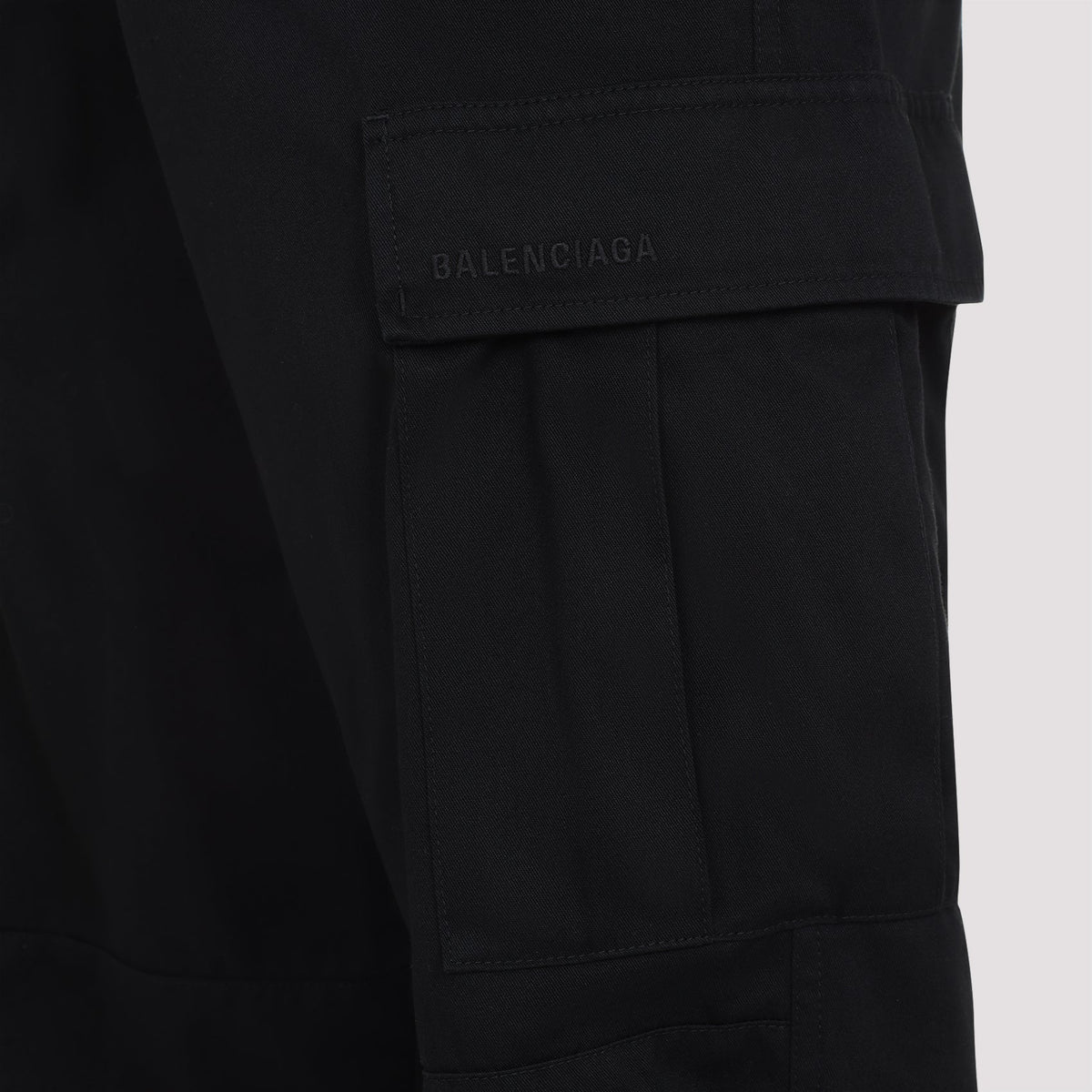 Close-up of Balenciaga pants hardware and fine stitching