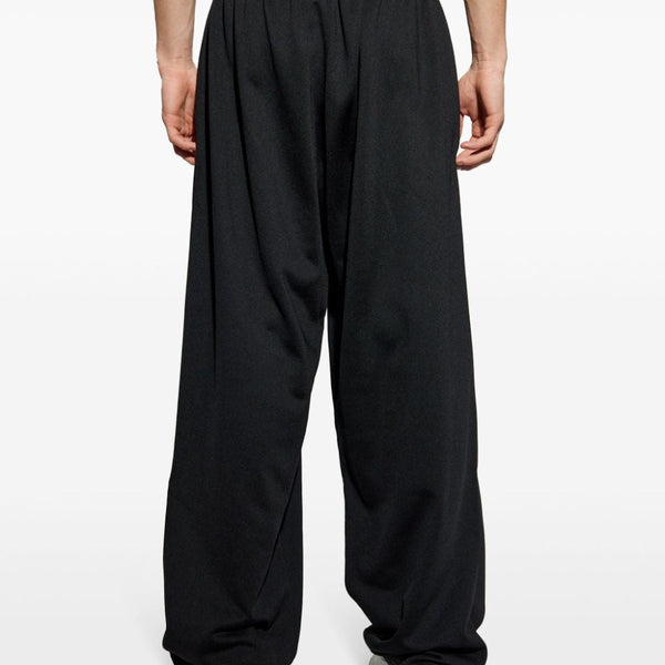 Close-up of Balenciaga pants hardware and fine stitching