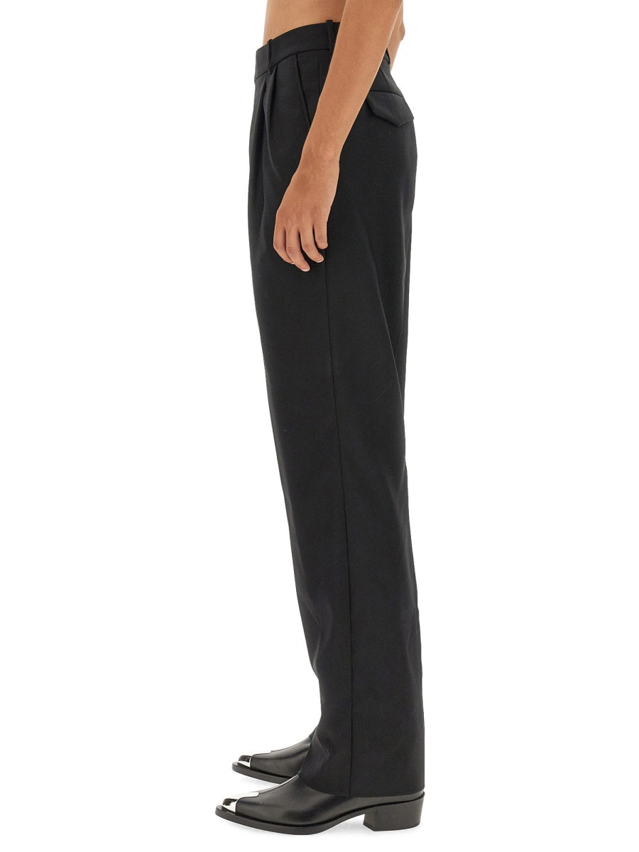 Close-up of Alexander McQueen pants hardware and fine stitching