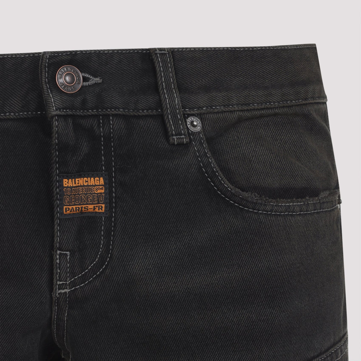 Close-up of Balenciaga pants hardware and fine stitching