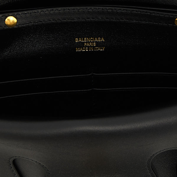 Close-up of Balenciaga clutches hardware and fine stitching