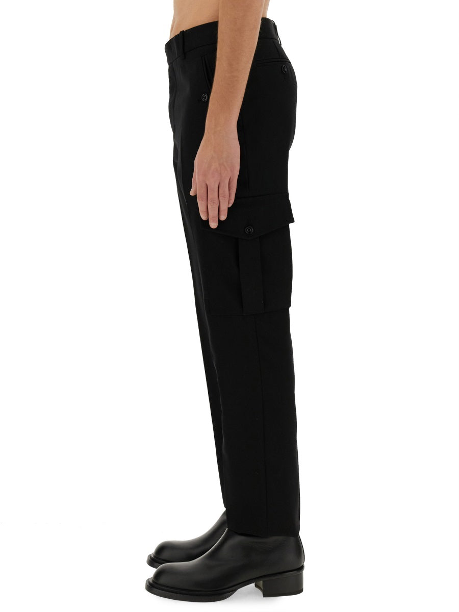 Close-up of Alexander McQueen pants hardware and fine stitching