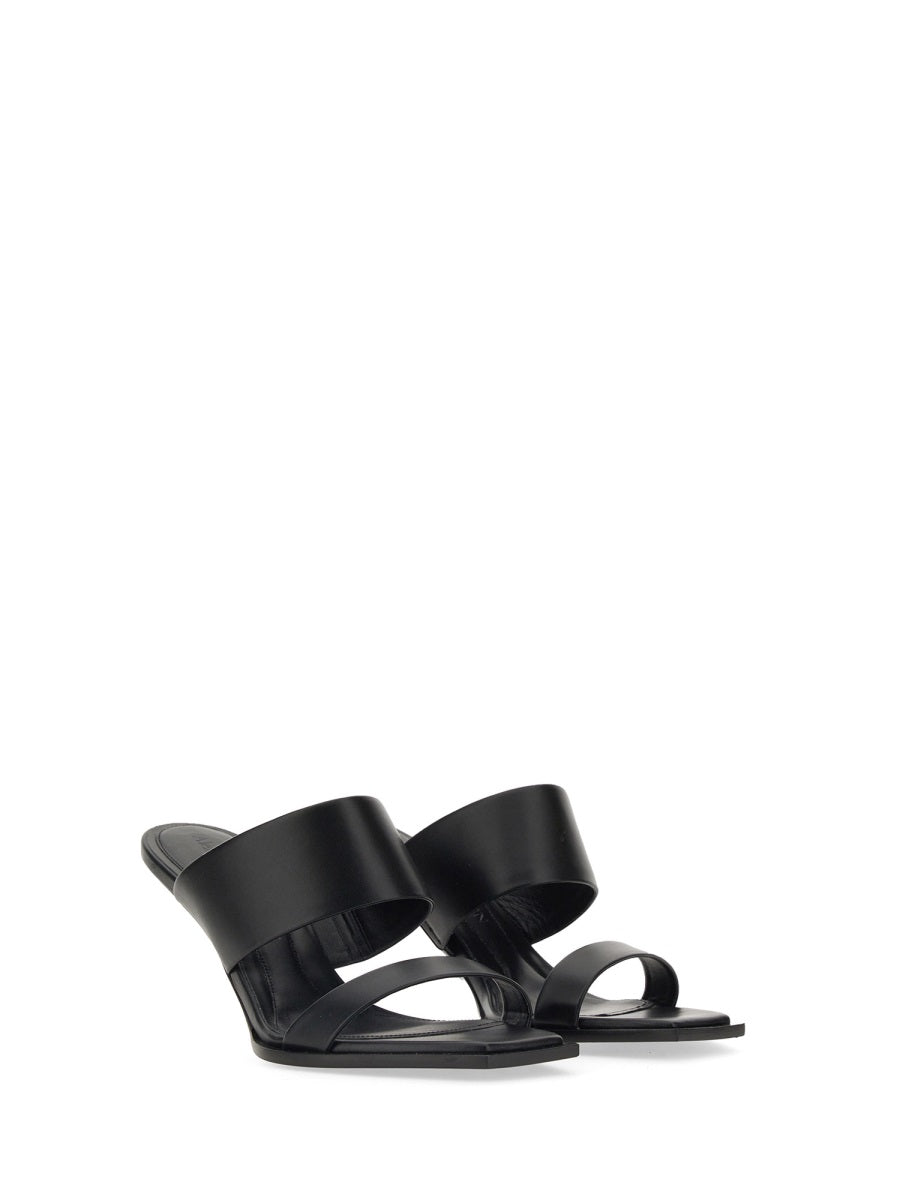Close-up of Alexander McQueen sandals hardware and fine stitching