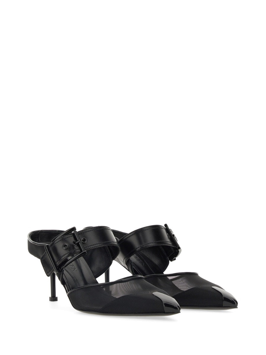 Close-up of Alexander McQueen sandals hardware and fine stitching