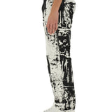 Close-up of Alexander McQueen pants hardware and fine stitching