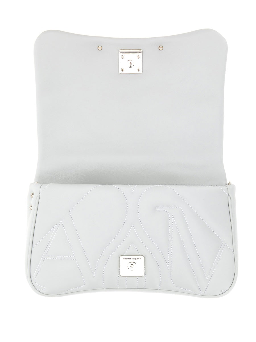 Close-up of Alexander McQueen cross body bags hardware and fine stitching