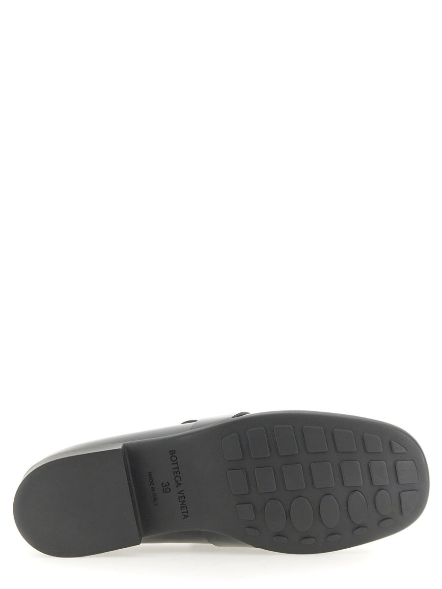 Close-up of Bottega Veneta slides hardware and fine stitching