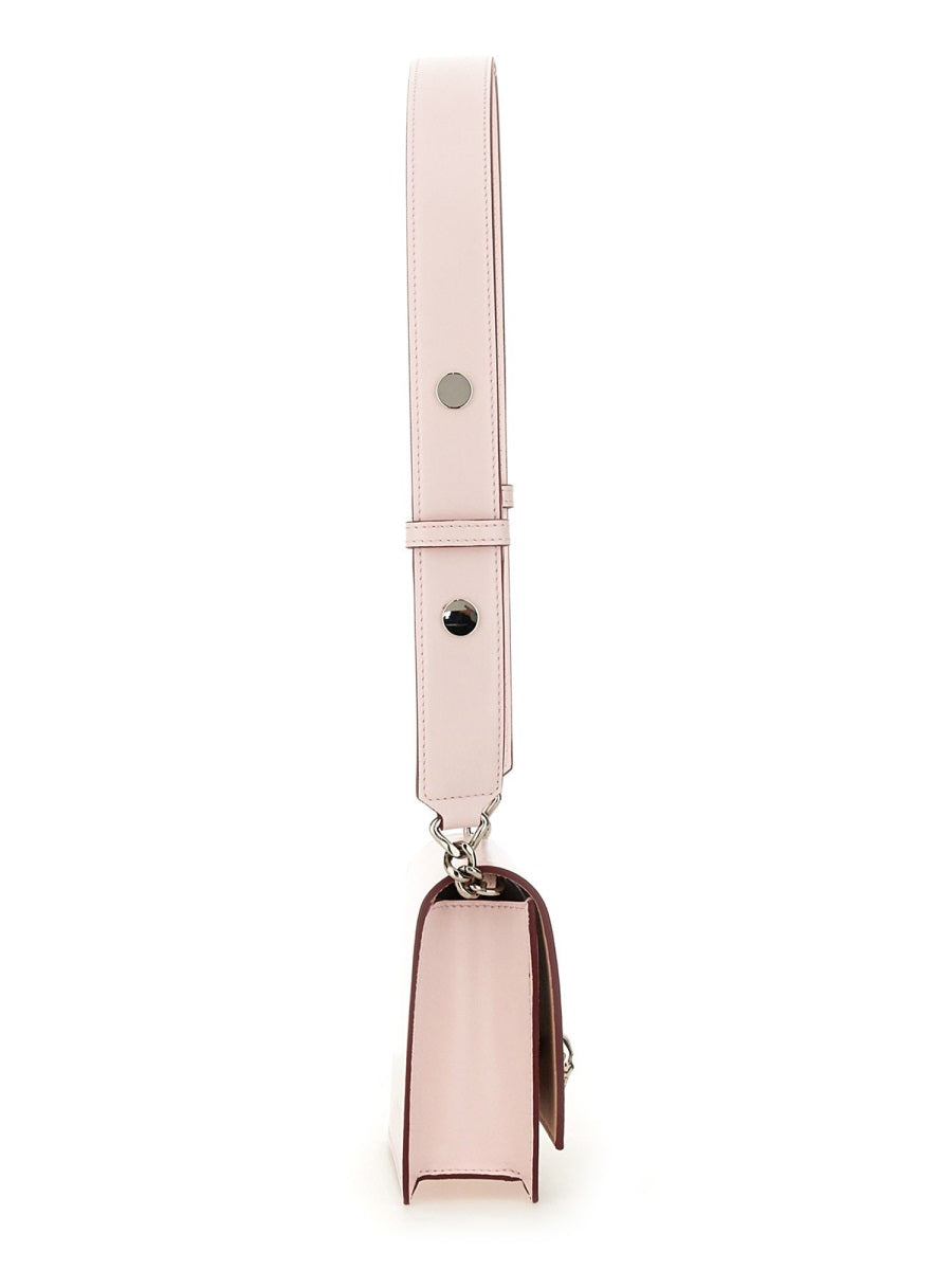 Close-up of Alexander McQueen cross body bags hardware and fine stitching