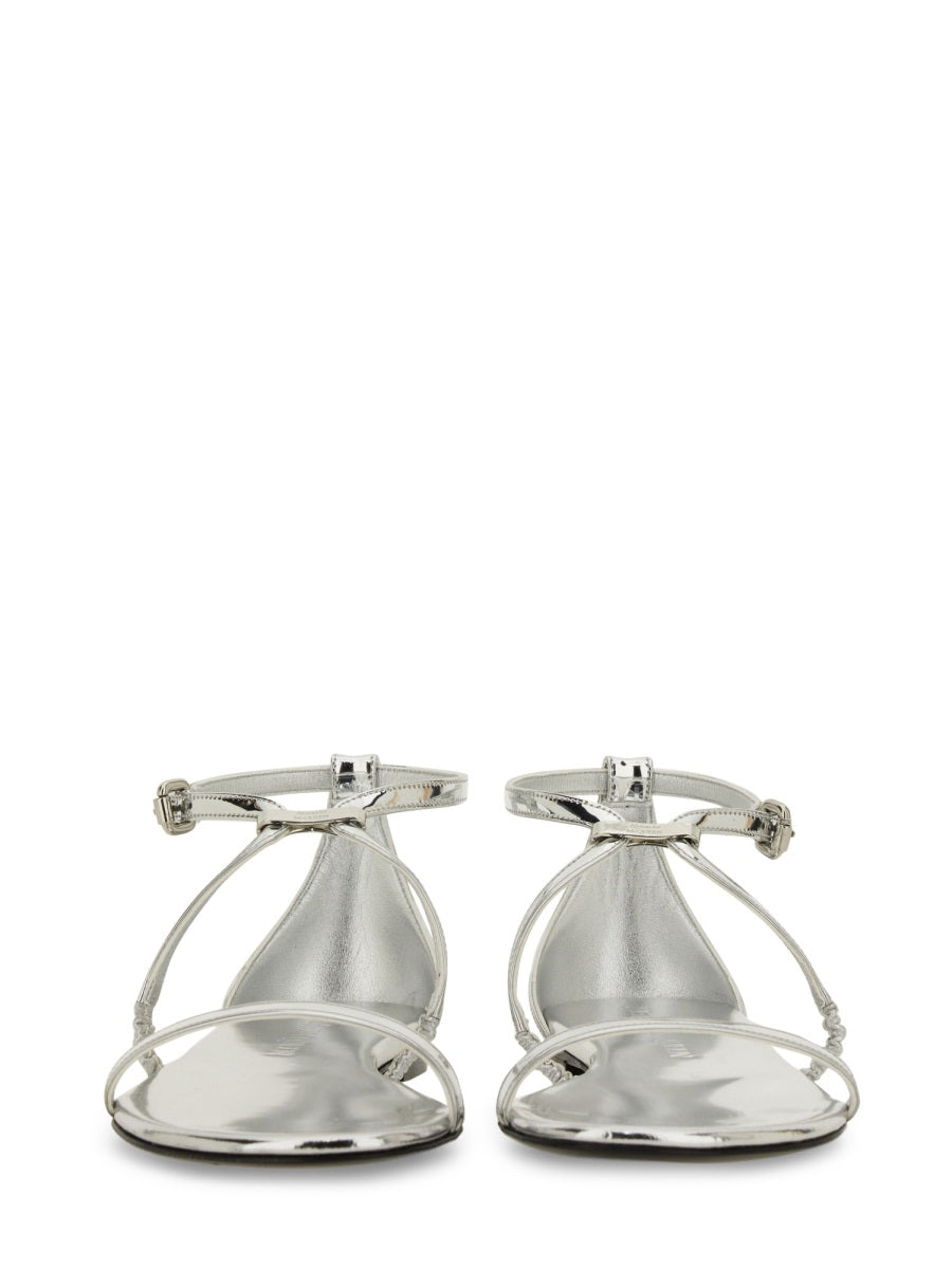 Close-up of Alexander McQueen sandals hardware and fine stitching