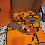 Hermès Black Slide Sandals - Close-Up Texture View
