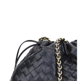 Close-up of Bottega Veneta clutches hardware and fine stitching