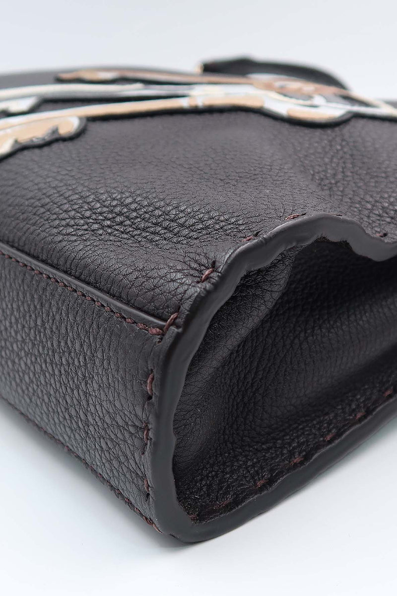 Close-up of Peekaboo bags hardware and fine stitching