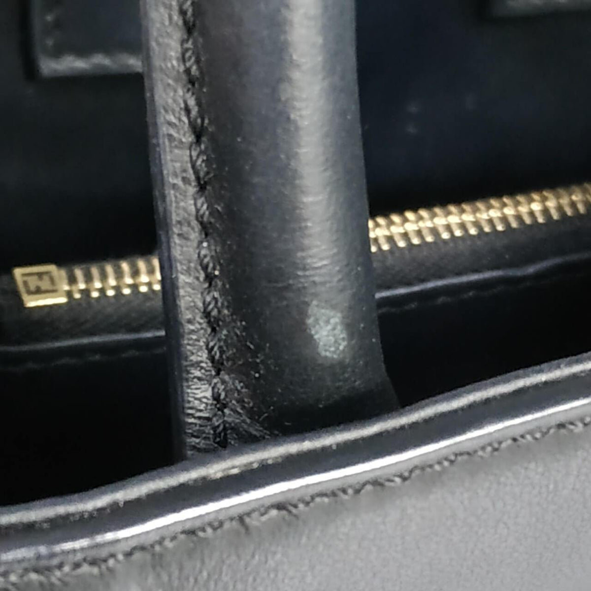 Close-up of Petite bags hardware and fine stitching