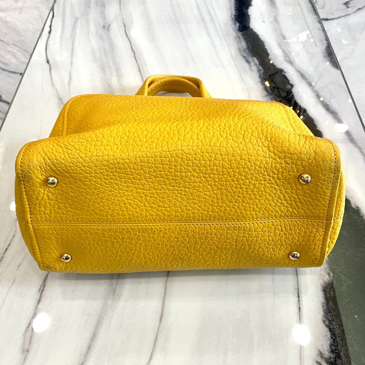 Close-up of Fendi satchel hardware and fine stitching
