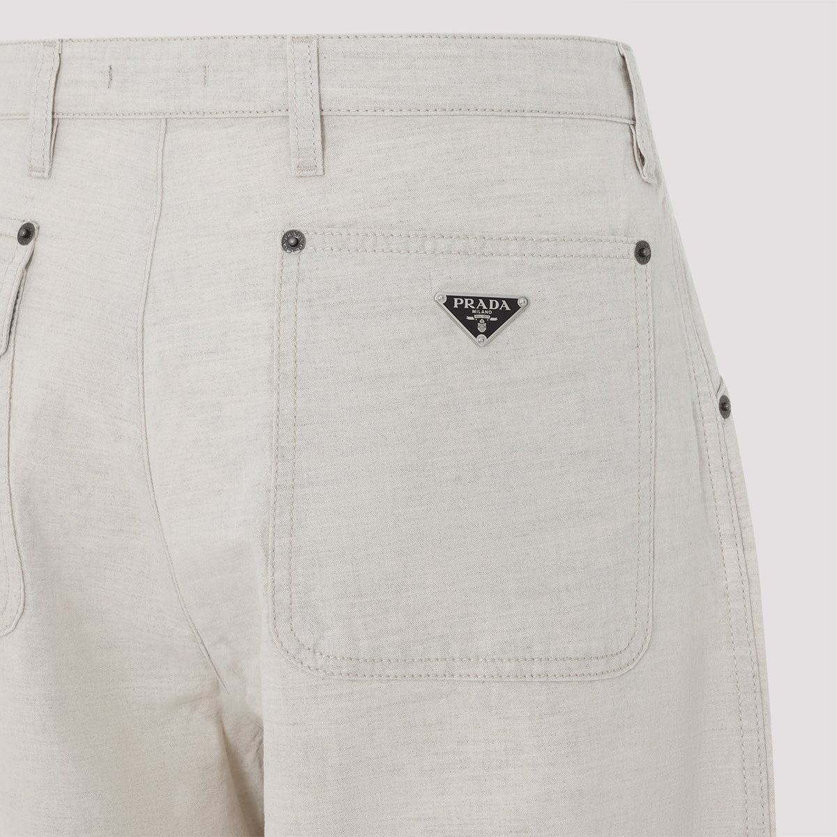 Close-up of Prada pants hardware and fine stitching