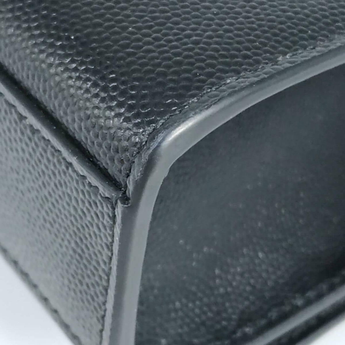 Close-up of Monogram bags hardware and fine stitching