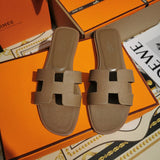 Hermès Black Flat Thong Sandals - Angled View