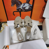 Hermès Beige Crisscross Strap Sandals - Angled View
