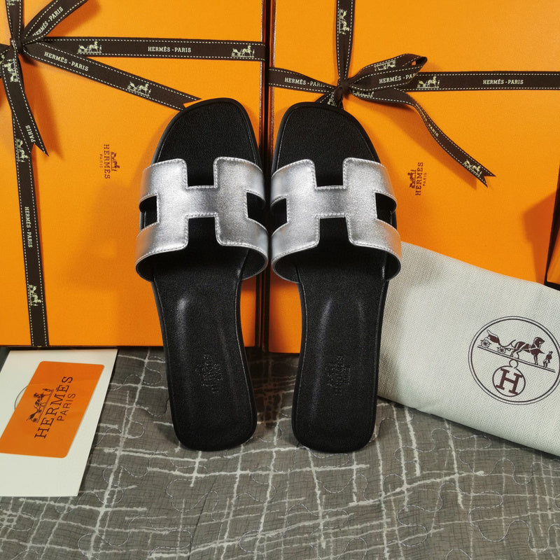 Hermès Tan Flat Thong Sandals - Angled View