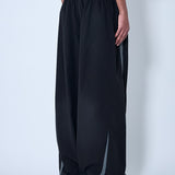 Close-up of Balenciaga pants hardware and fine stitching