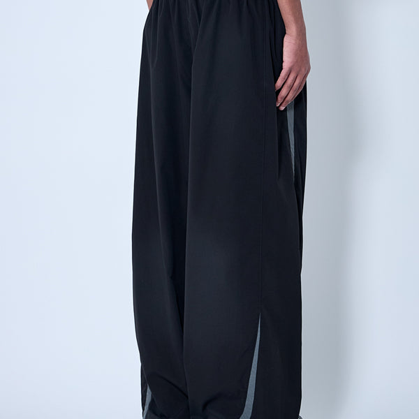 Close-up of Balenciaga pants hardware and fine stitching