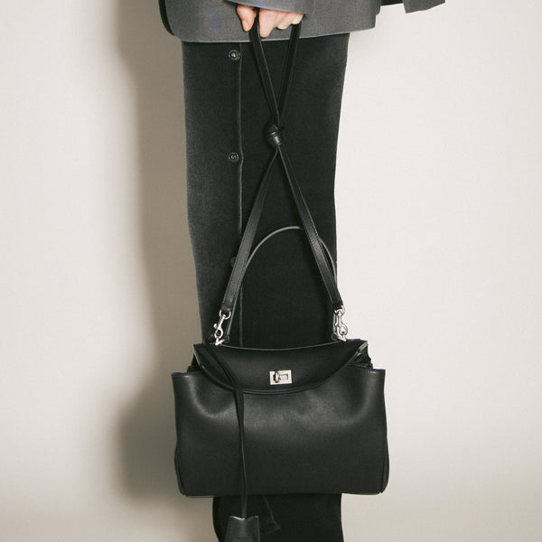 Close-up of Balenciaga cross body bags hardware and fine stitching