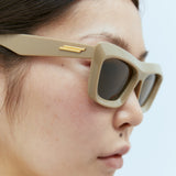 Close-up of Bottega Veneta sunglasses hardware and fine stitching