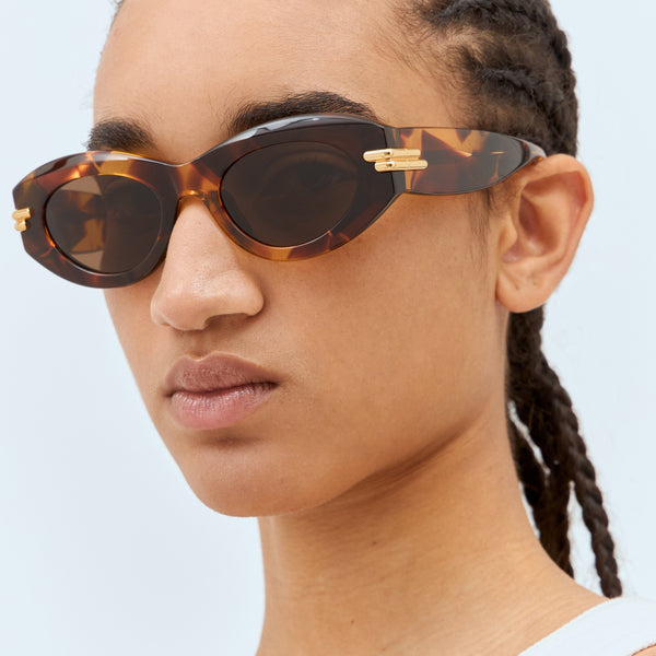 Close-up of Bottega Veneta sunglasses hardware and fine stitching