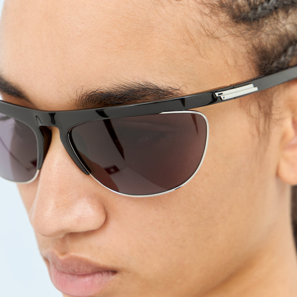 Close-up of Bottega Veneta sunglasses hardware and fine stitching