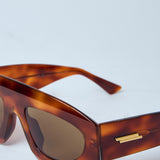 Close-up of Bottega Veneta sunglasses hardware and fine stitching