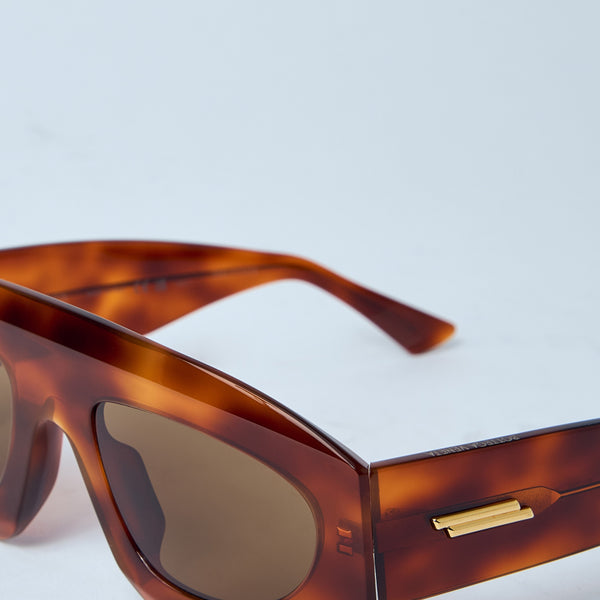 Close-up of Bottega Veneta sunglasses hardware and fine stitching