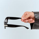 Close-up of Bottega Veneta sunglasses hardware and fine stitching