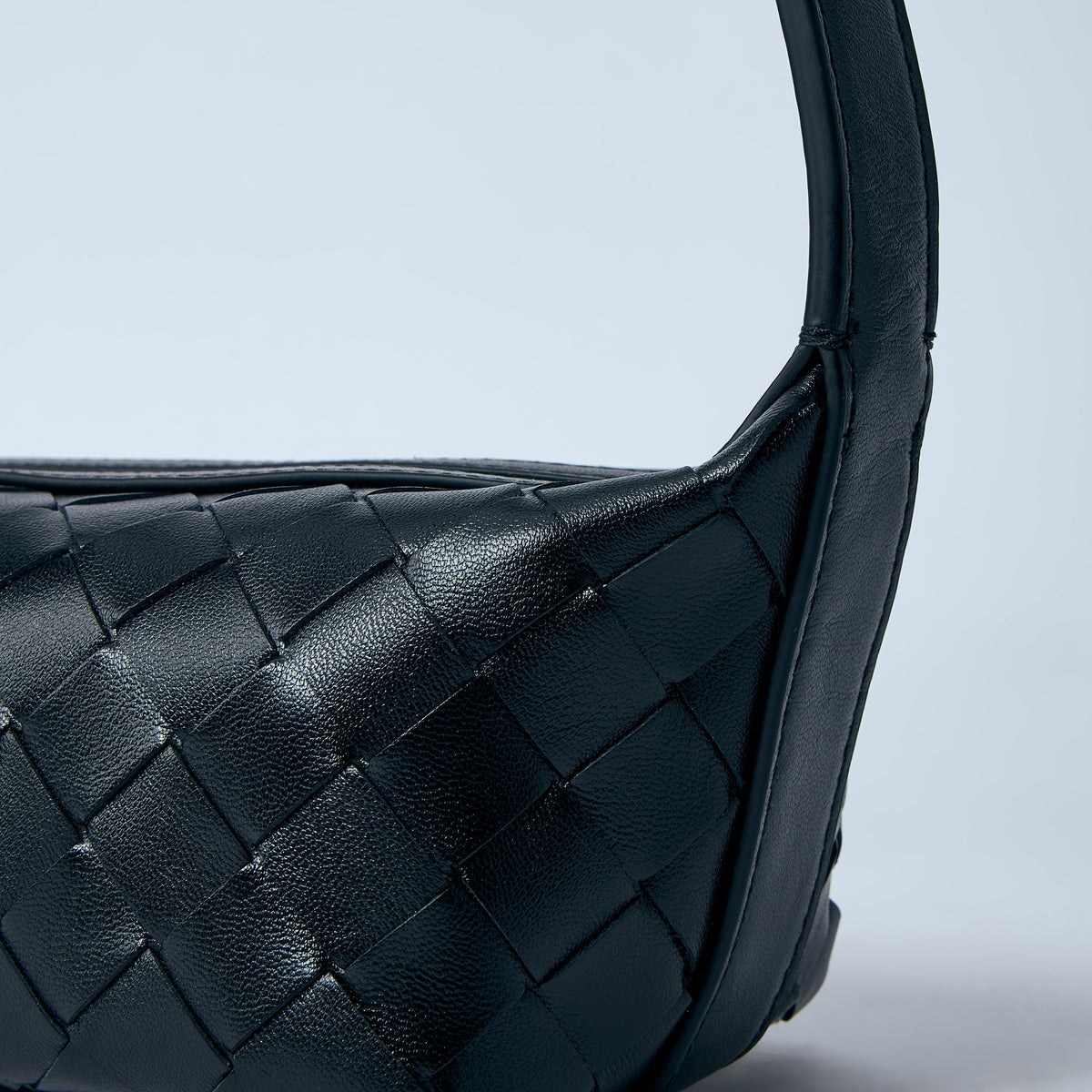 Close-up of Bottega Veneta shoulder bags hardware and fine stitching