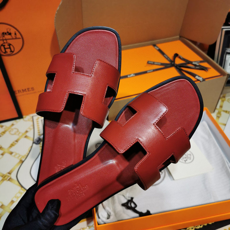 Hermès Grey Flat Thong Sandals - Angled View