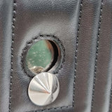 Close-up of DotCom bags hardware and fine stitching