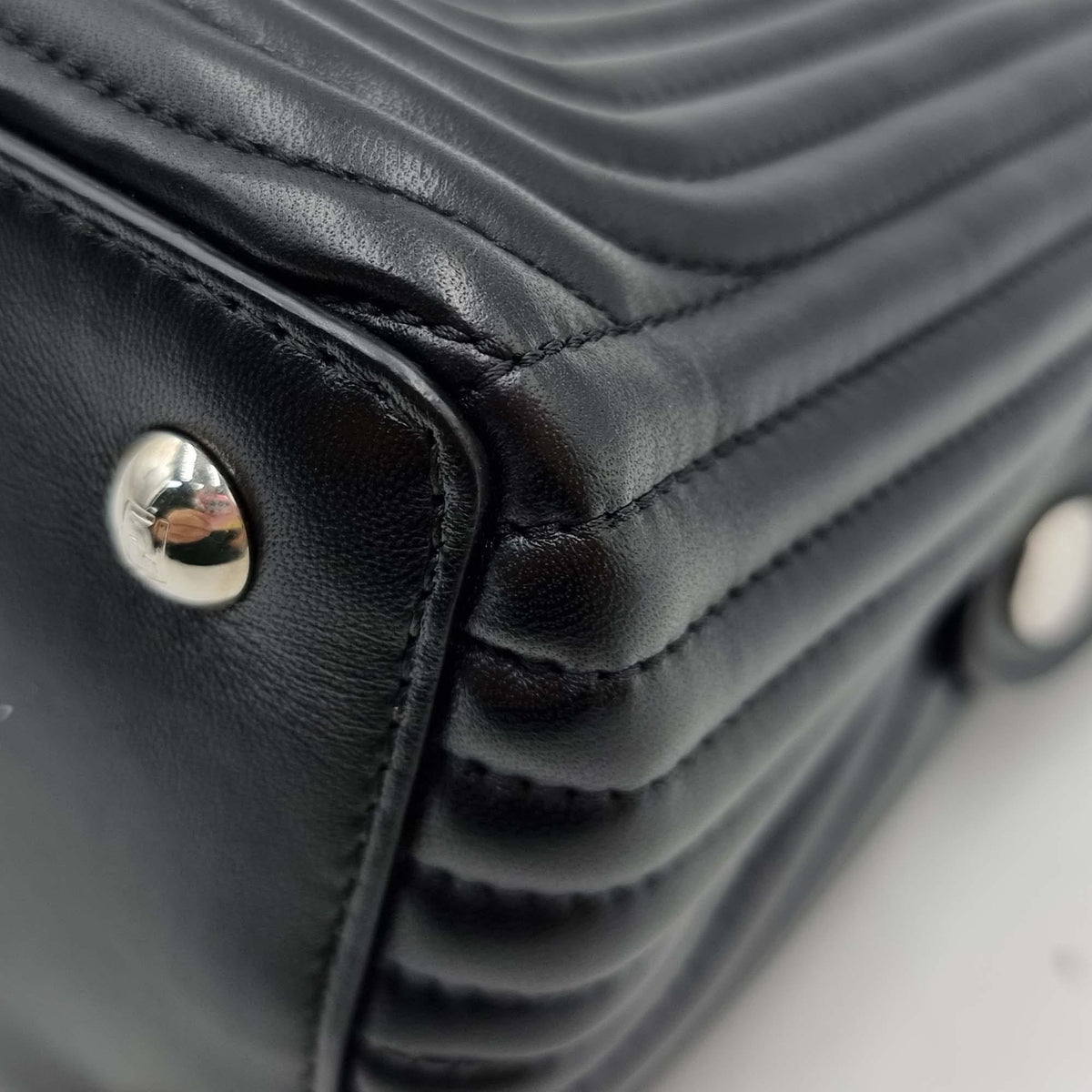Close-up of DotCom bags hardware and fine stitching