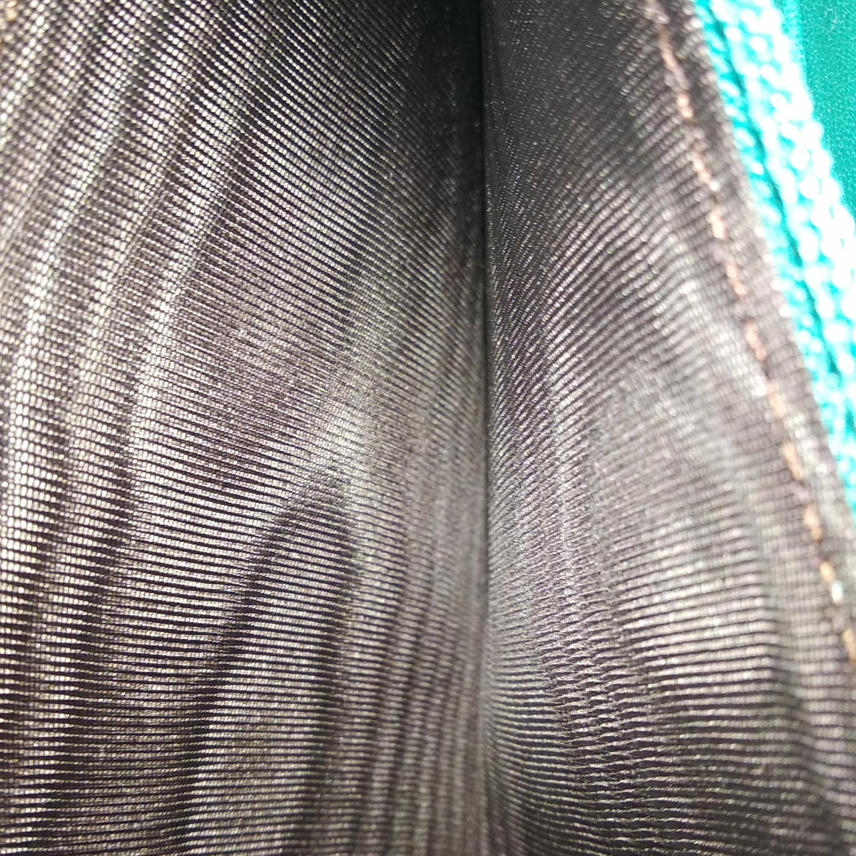 Close-up of Patent bags hardware and fine stitching