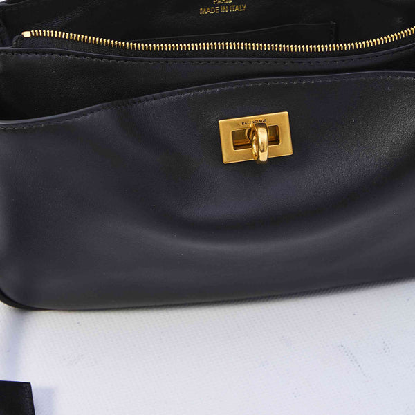 Close-up of Balenciaga cross body bags hardware and fine stitching