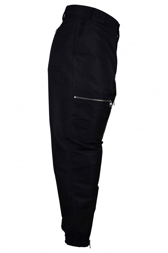 Close-up of Alexander McQueen pants hardware and fine stitching