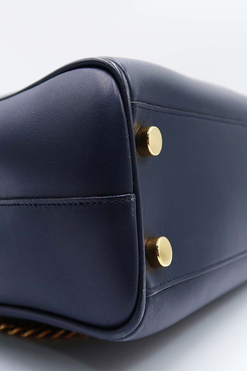 Close-up of Cassandre bags hardware and fine stitching