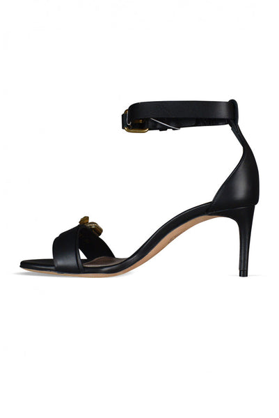 Close-up of Alexander McQueen sandals hardware and fine stitching