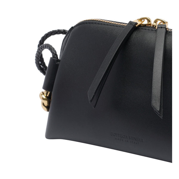Close-up of Bottega Veneta clutches hardware and fine stitching