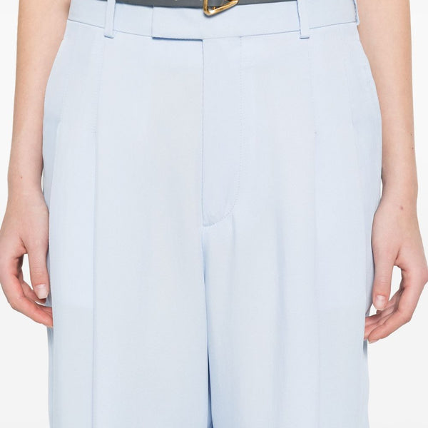 Close-up of Bottega Veneta pants hardware and fine stitching